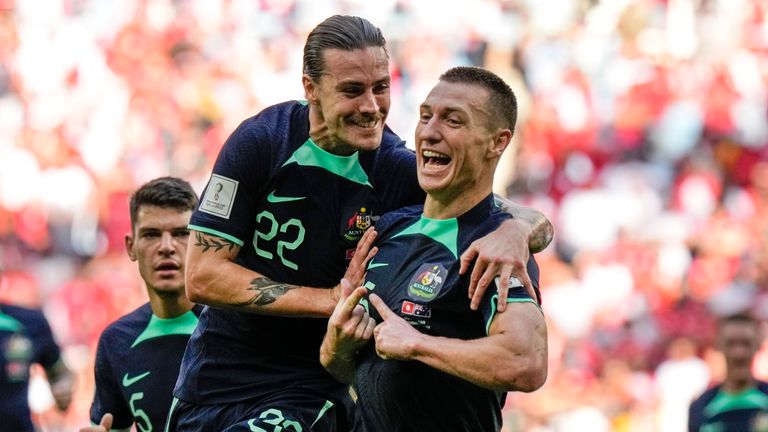 Australia's scorer Mitchell Duke, right, celebrates with teammate Australia's Jackson Irvine, left, after he scored the opening goal during the World Cup group D soccer match between Tunisia and Australia at the Al Janoub Stadium in Al Wakrah, Qatar, Saturday, Nov. 26, 2022. (AP Photo/Luca Bruno)